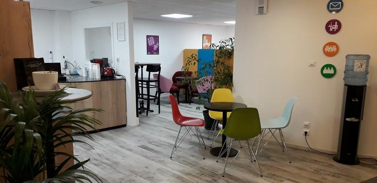 Vibrant communal breakout area with colorful chairs and a water station at Angers, 6 Place Bichon, Angers.
