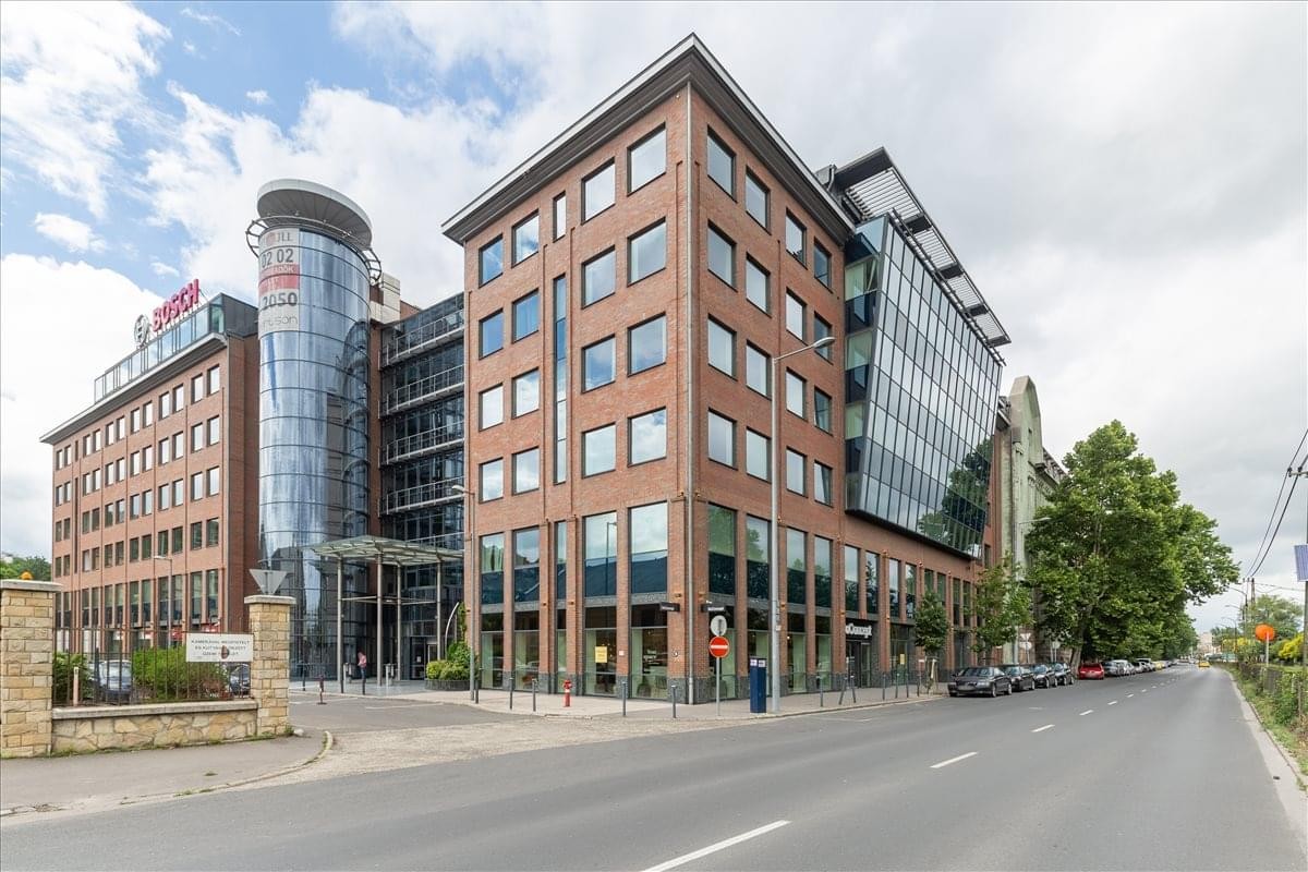 Exterior view of the brick and glass office building at Arpad Fejedelem utja 26-28.