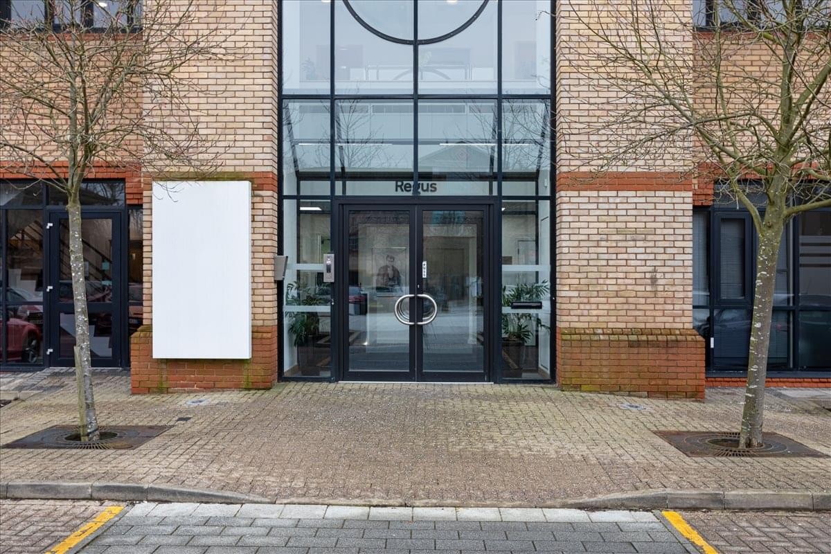 Exterior view of the brick and glass entrance at Aston Court, Kingsmead Business Park.
