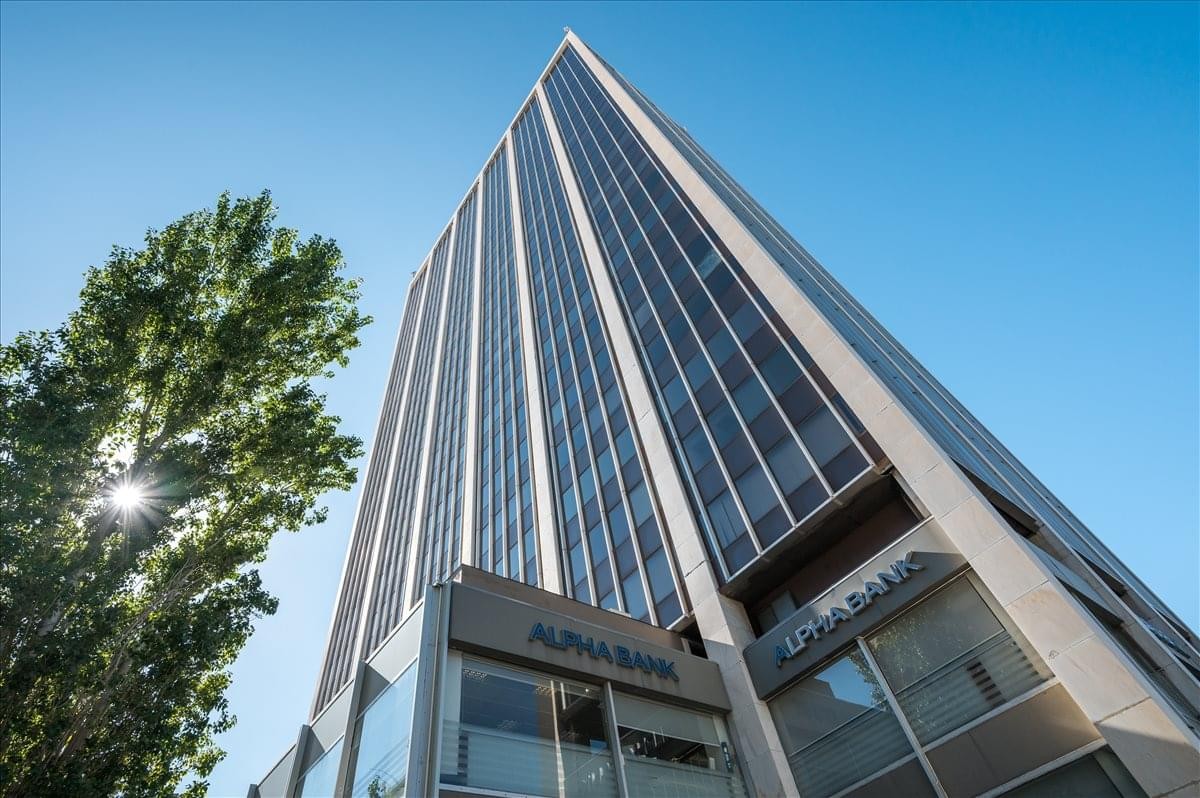 Exterior view of the landmark Athens Towers high-rise skyscraper under a clear blue sky.