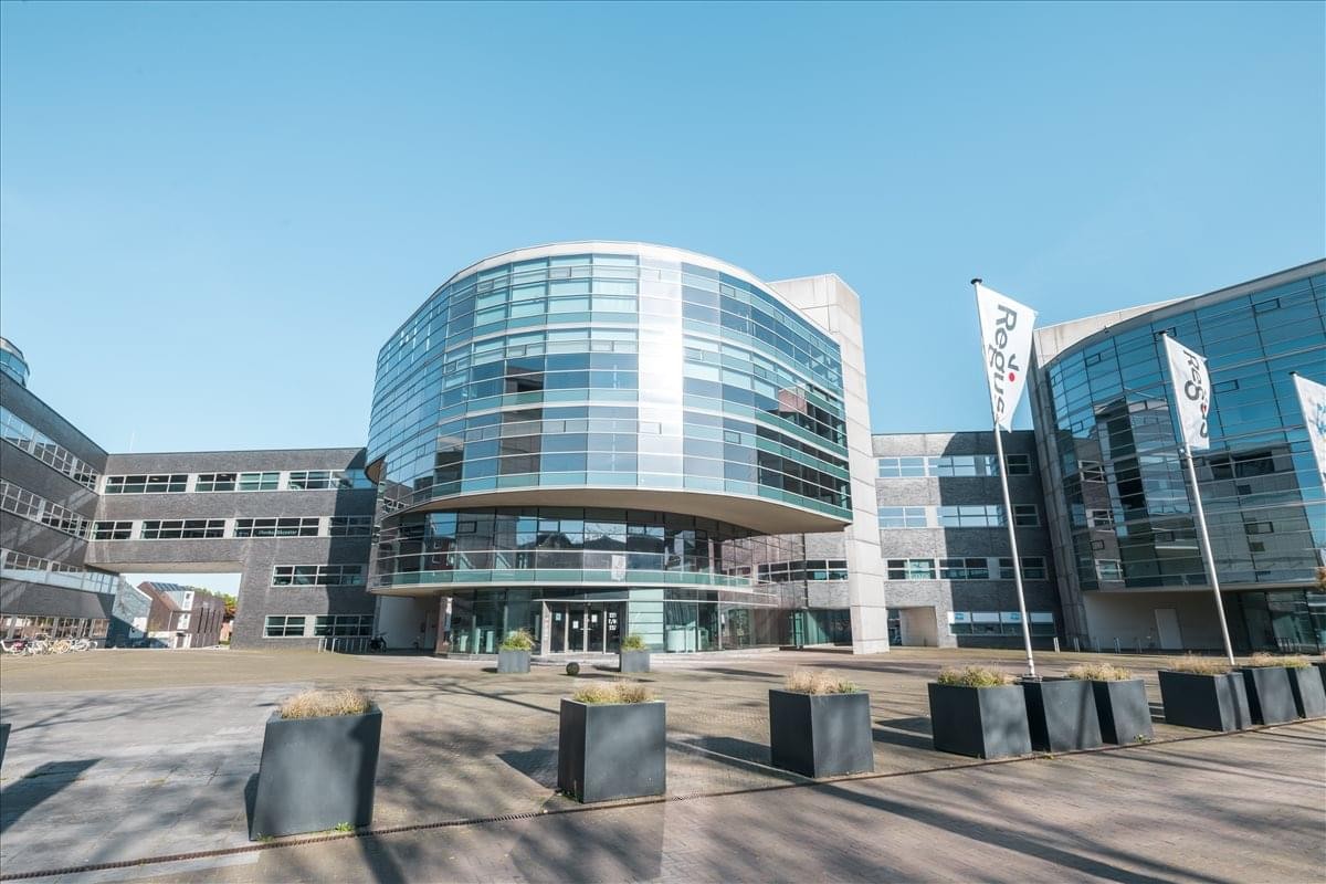 Exterior view of the modern curved glass facade at Avenue Ceramique 221.