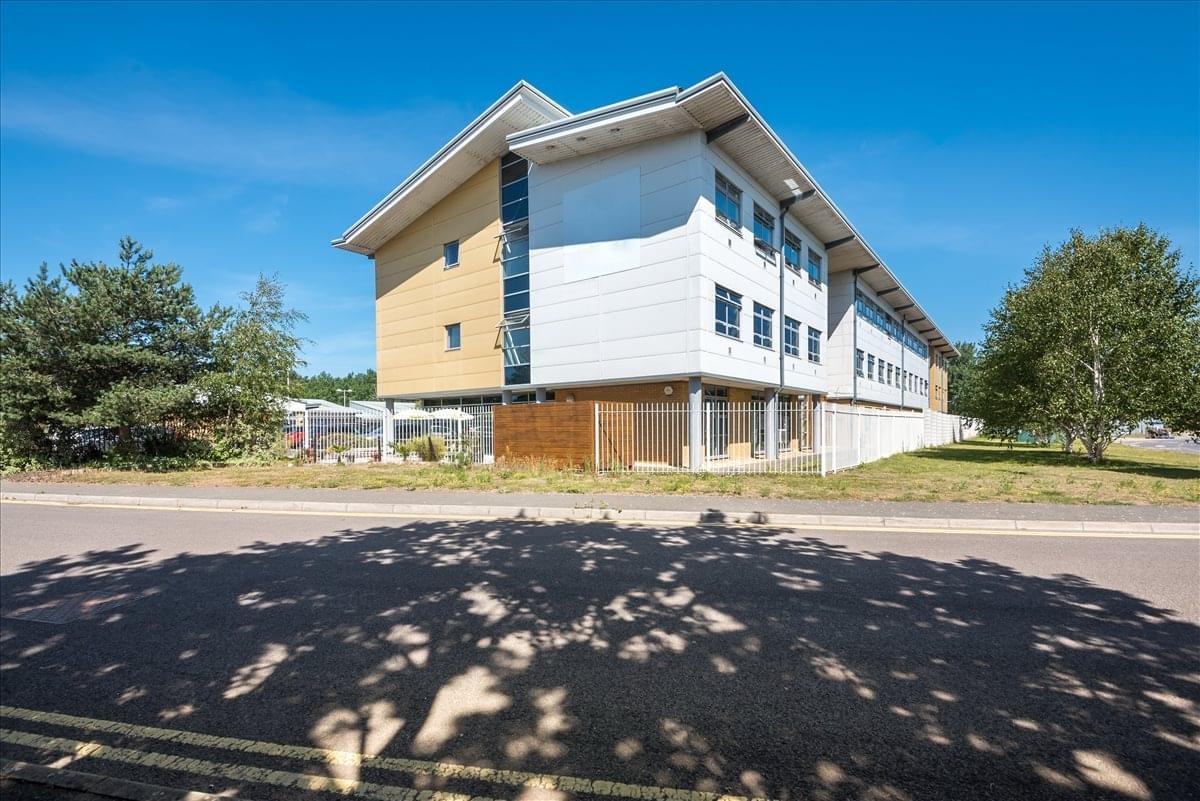 Modern exterior of Aviation Business Park, Enterprise Close, showing the three-story building facade.