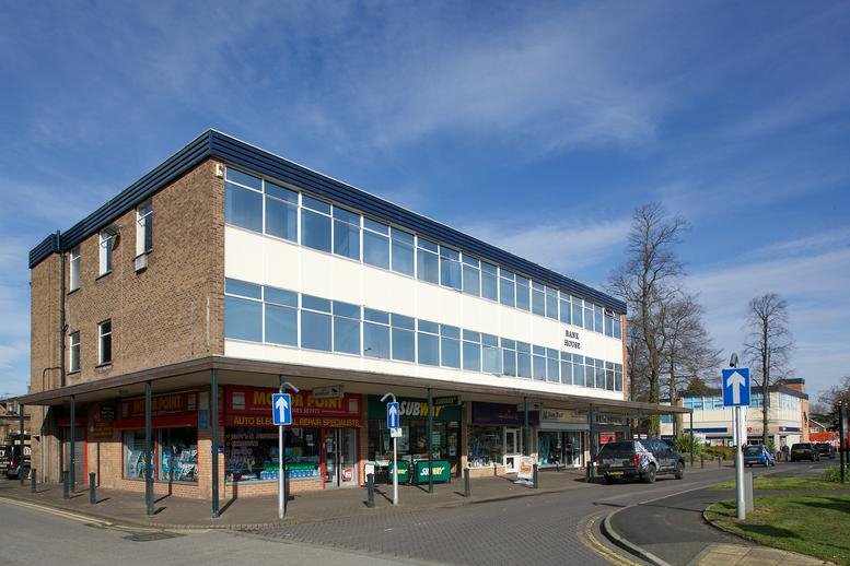 Exterior view of the multi-story brick and glass facade of Bank House, The Paddock.