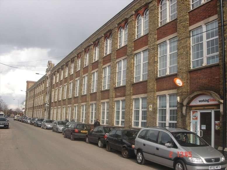 Exterior view of the red brick and stone facade of Berol House on a city street.