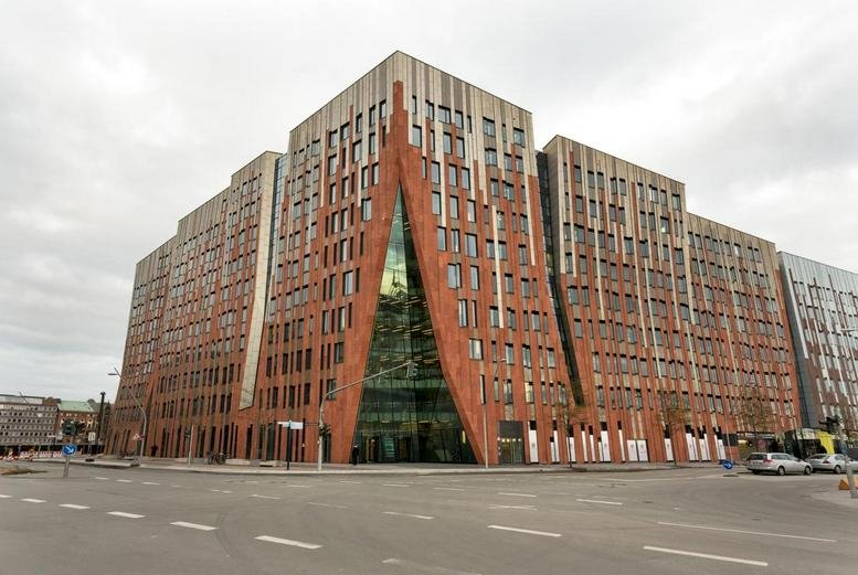 Exterior view of the uniquely designed Sumatrakontor building with its striking red brick and glass facade.