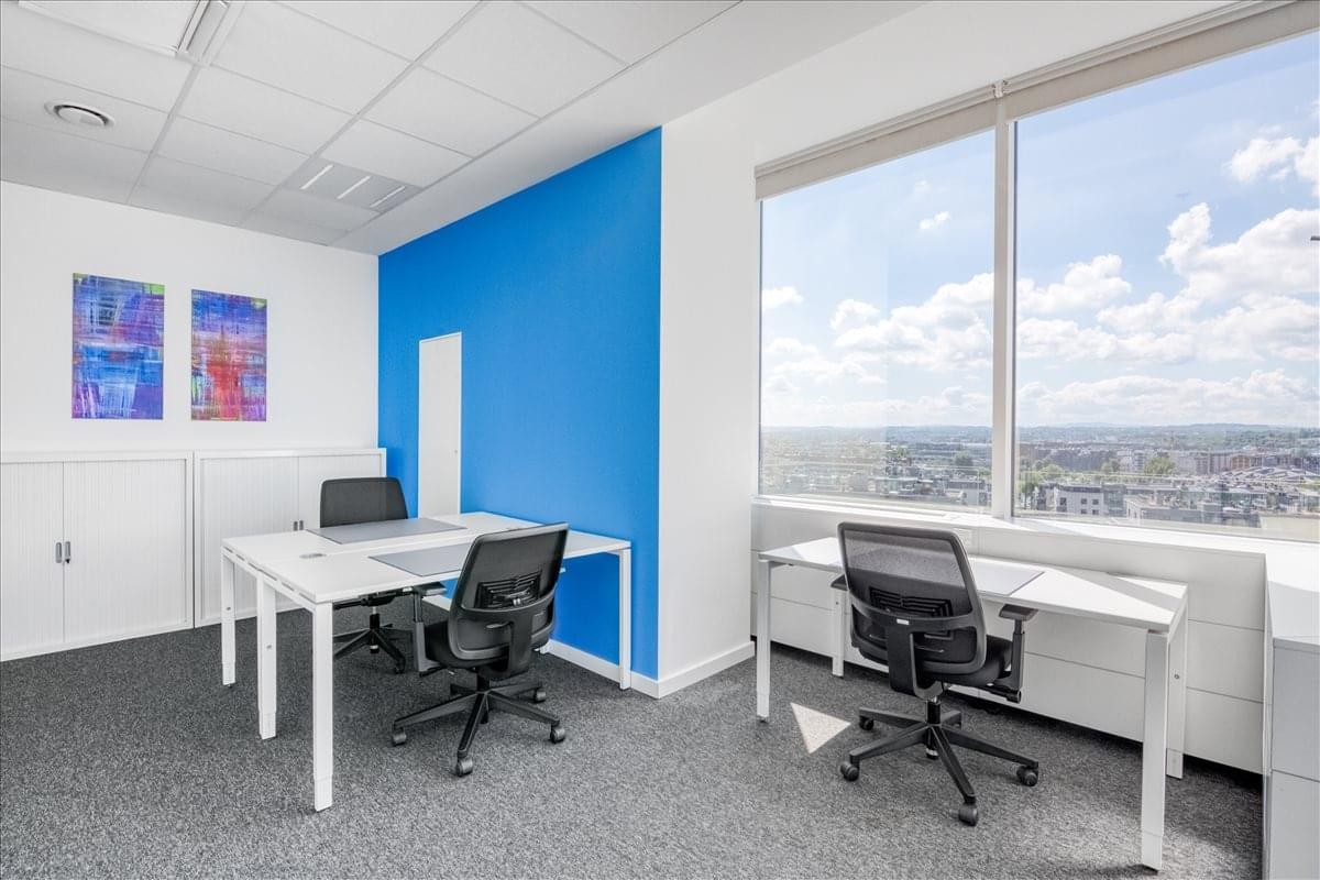 Private office at BF Krakow, Grzegórzki (II) featuring a blue accent wall and city views.