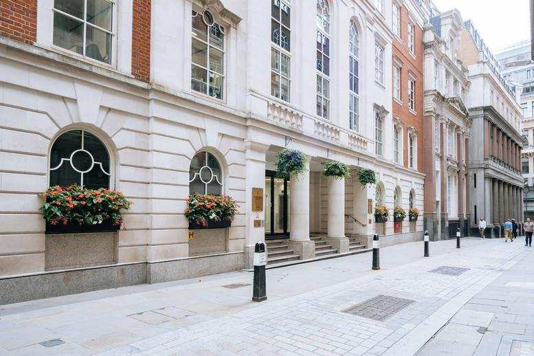 Grand stone facade of Birchin Court, 20 Birchin Lane, featuring classic arched windows and pillars.