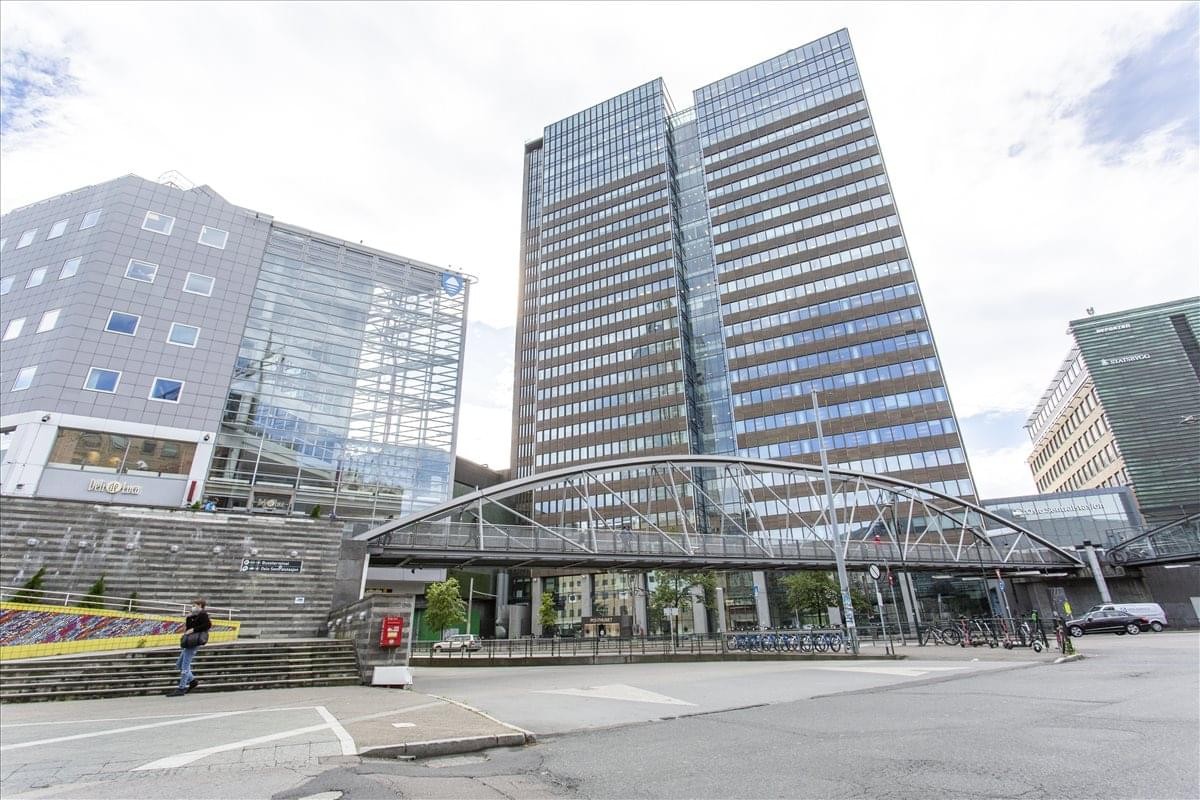 Exterior view of the modern glass and stone building at Biskop Gunnerus Gate 14.