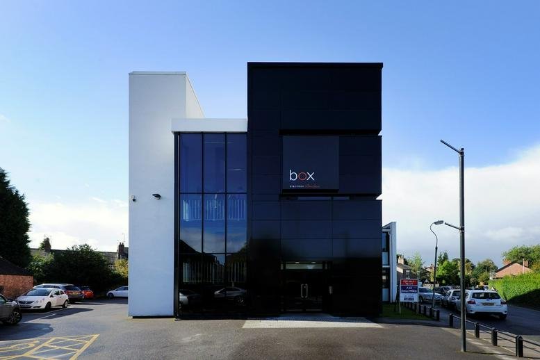 Exterior view of the modern black and white facade at Blackbox Wilmslow.