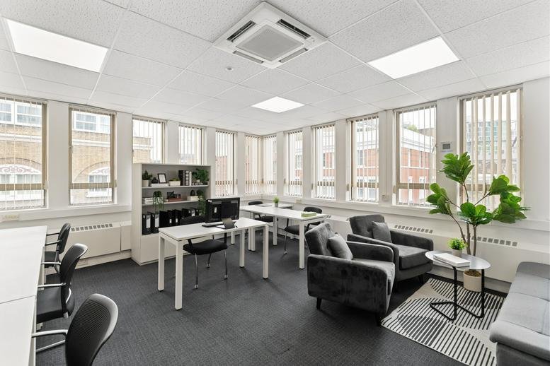 Spacious open-plan workspace at Alpha House, 100 Borough High Street, featuring desks and a lounge area.