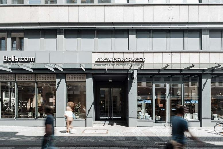 Street-level exterior view of ABC Workspaces at Brückenstrasse 2 featuring a glass-fronted facade.