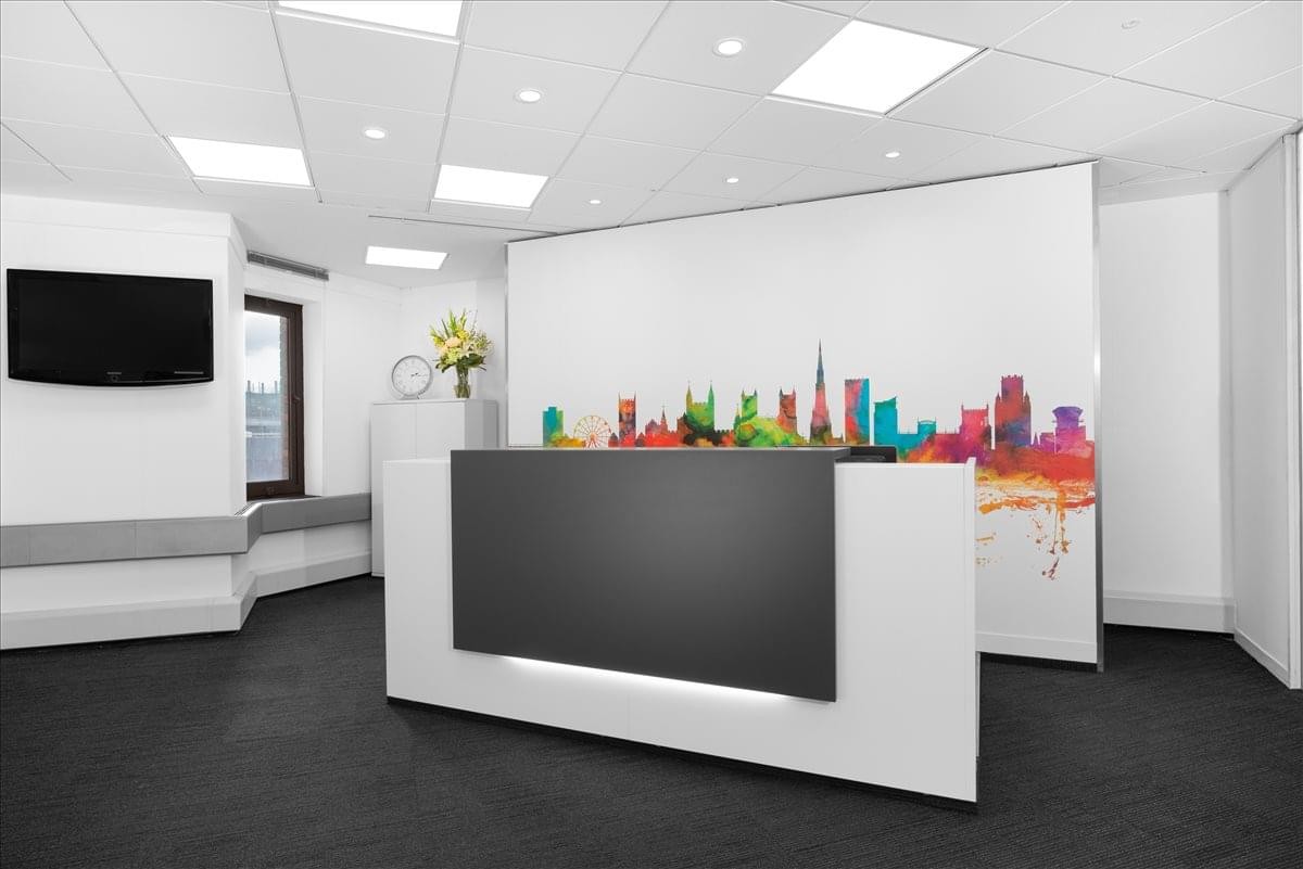 Professional reception area with a minimalist white desk and colorful skyline mural.