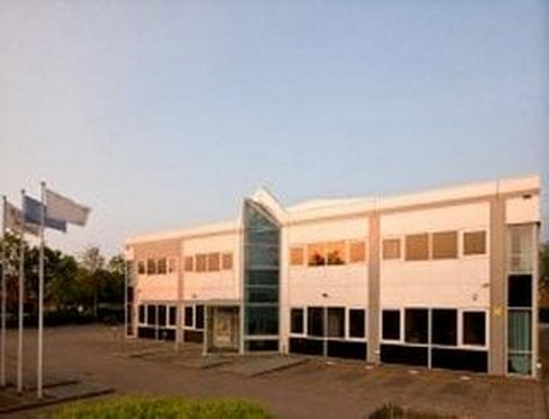 Exterior view of the white facade and glass entrance at Brook House, 54A Cowley Mill Road.