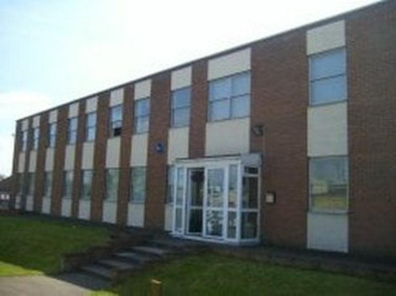 Exterior view of the brick facade and glass entrance at Brook House, Edmonds Close, Denington Industrial Estate.
