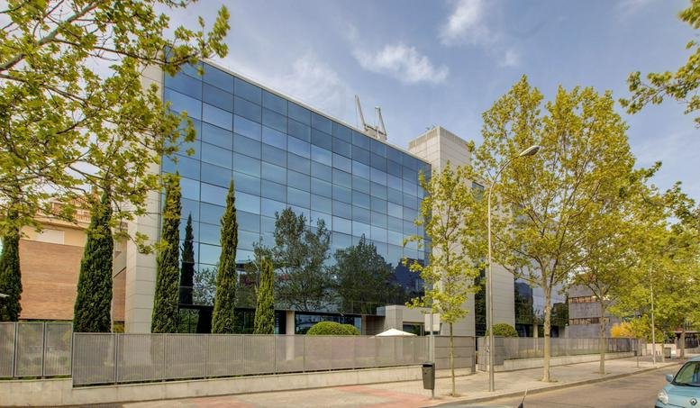 Exterior view of the glass-facade building at Calle Bahia de Pollensa, No. 5, Madrid.
