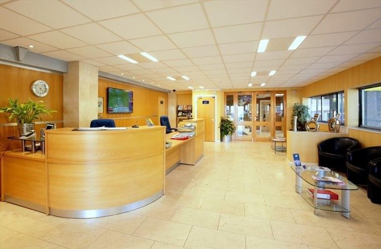 Welcoming reception area at Cardiff House, Cardiff Road with a curved wood desk and tile flooring.