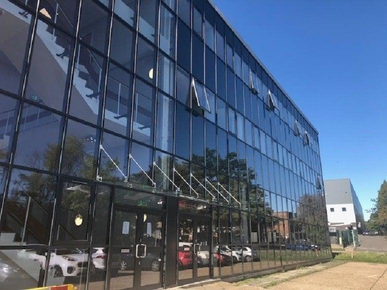 Exterior view of the glass-facade building at Caxton Point, Caxton Way.