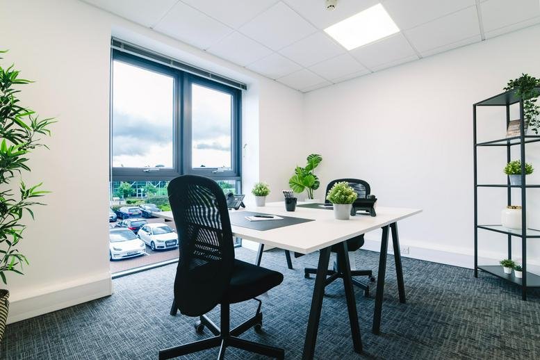 Exterior view of the contemporary white and grey facade at Cheltenham Office Park.