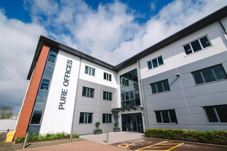 Exterior view of the modern Cheltenham Office Park building at Hatherley Lane.