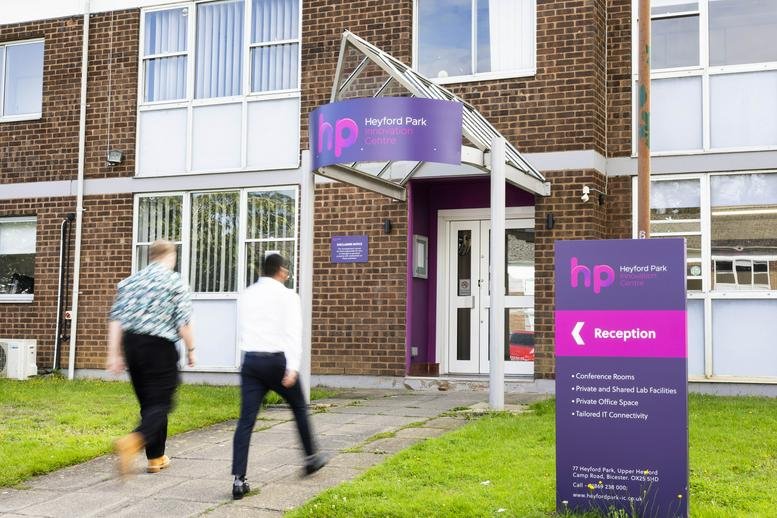 Exterior entrance with purple signage at Cherwell Innovation Centre, 77 Heyford Park.