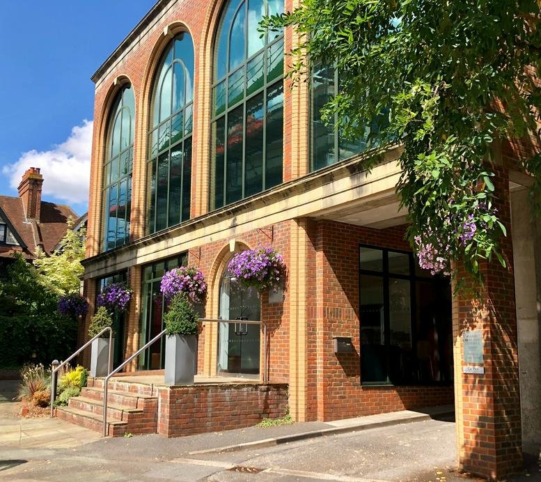 Exterior view of the red brick and arched glass facade of Chiltern House, 45 Station Road.