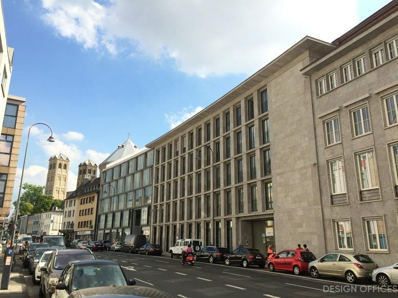 Exterior view of the modern stone and glass facade of Christophstrasse 15-17.