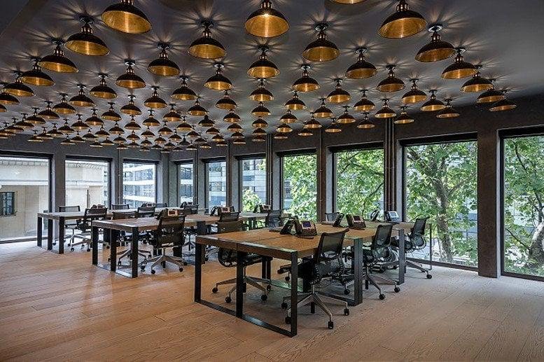 Large open-plan workspace at City Pavilion, Cannon Green featuring a ceiling covered in gold pendant lights.