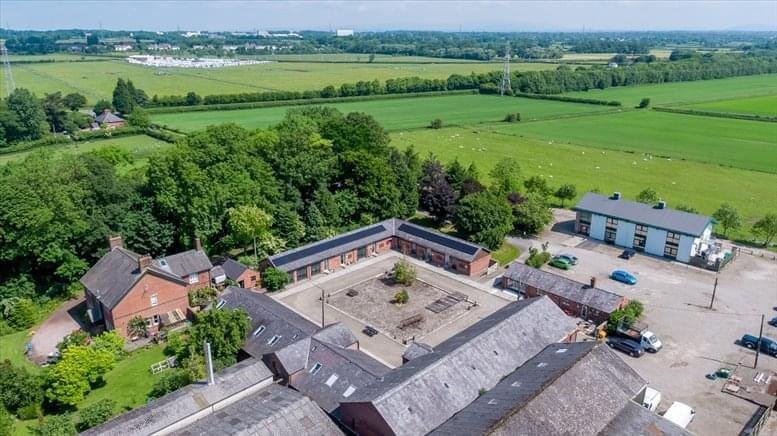 Aerial view of the rural brick buildings at Clifton Fields, Lytham Road surrounded by green fields.