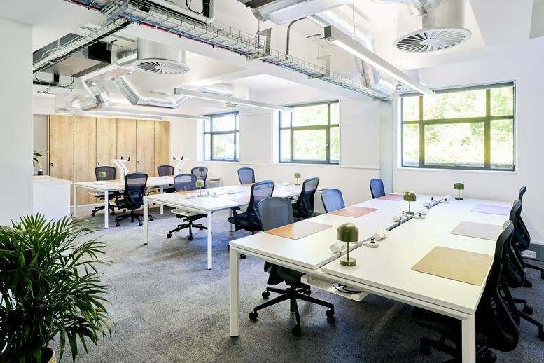 Spacious open-plan workspace at Eagle House, Colston Avenue with white desks and industrial-style ceilings.