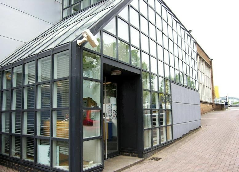 Exterior view of the glass-fronted entrance at CP House, Otterspool Way.