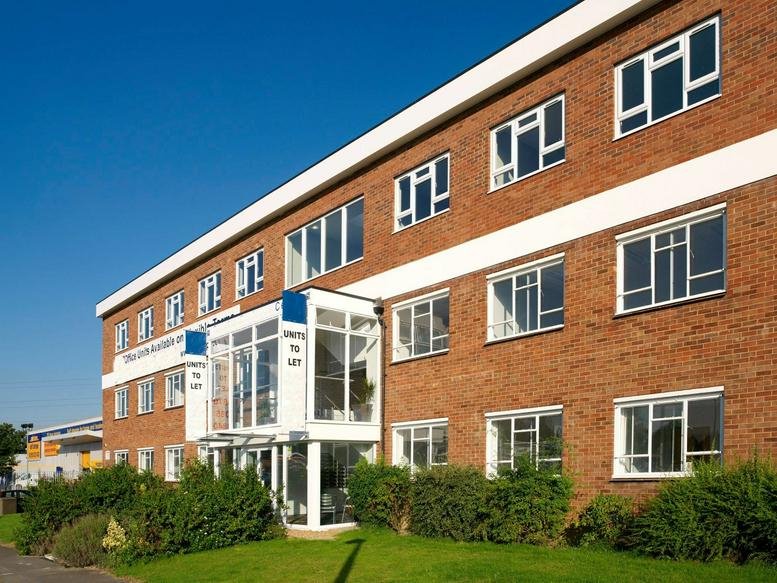 Exterior view of the brick facade and glass entrance at Crawley Business Centre, Stephenson Way.