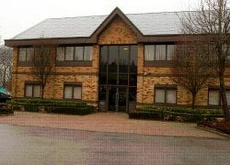 Exterior view of Cromwell Park with a modern brick facade and trees.