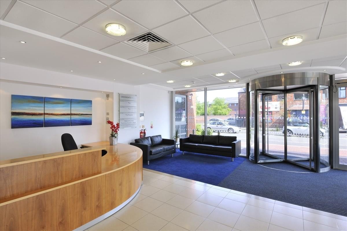 Modern lobby and wooden reception desk at Crossgate House, Cross Street, Manchester.