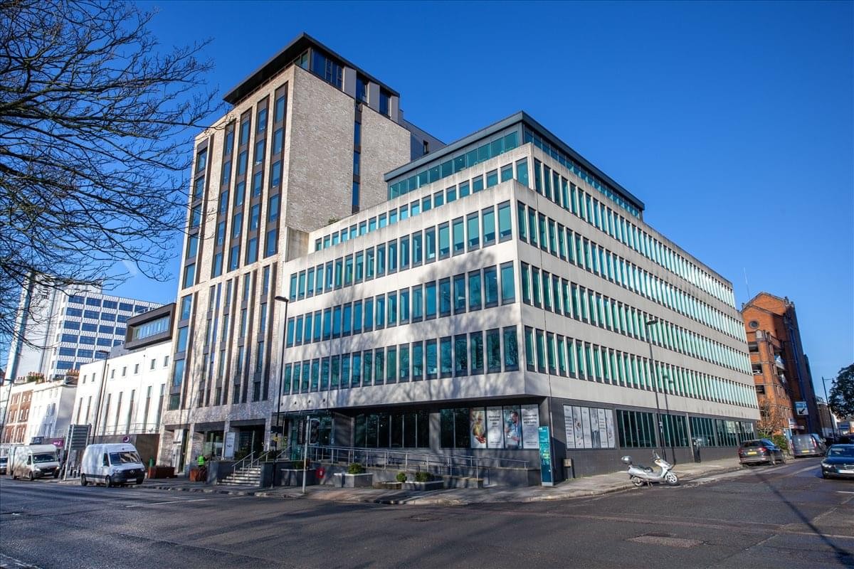 Exterior view of Cumberland House with glass facade on a sunny day.