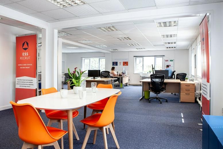 Spacious open-plan workspace at Dalgety Bay, Ridge Way, Dalgety Bay, Fife, featuring orange chairs and desks.