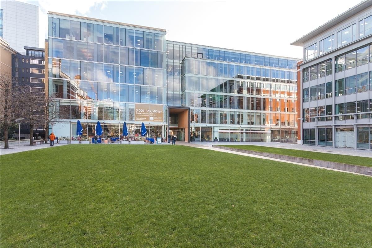 Exterior view of the modern glass-fronted Davidson House, Forbury Square overlooking a public green.