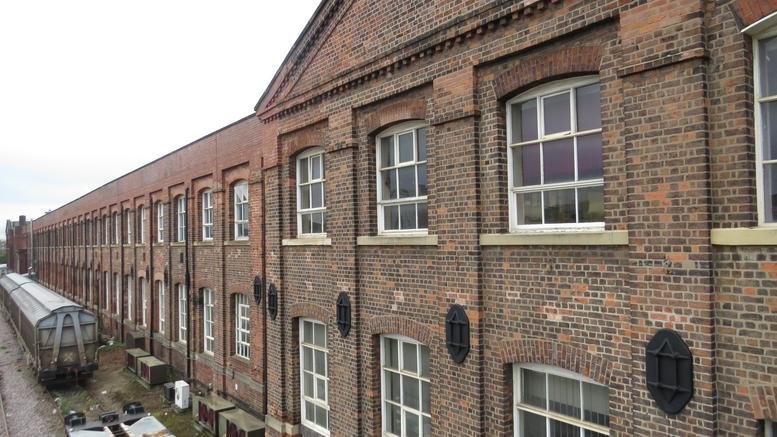Exterior brick facade of the historic Denison House (Off Hexthorpe Road) featuring large multi-pane windows.