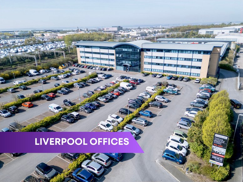 High-angle exterior view of the multi-storey Dylan Harvey Business Centre with a large car park.