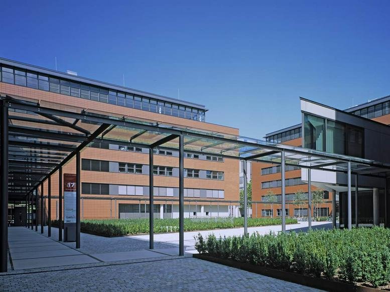Exterior view of the modern red brick and glass buildings at Dynamostraße 13.