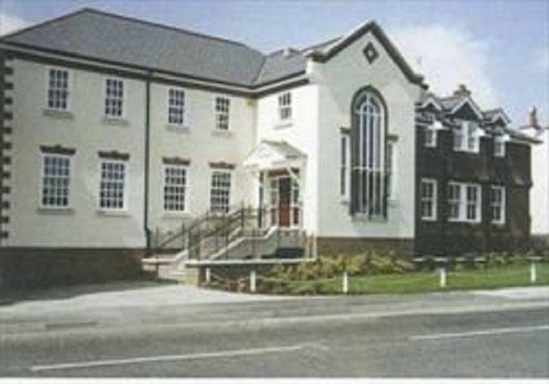 Exterior view of the white and dark wood facade at Eastgate, Dogflud Way, Farnham, Surrey.