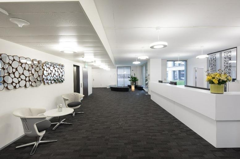 Reception area with modern seating and decorative wall art.