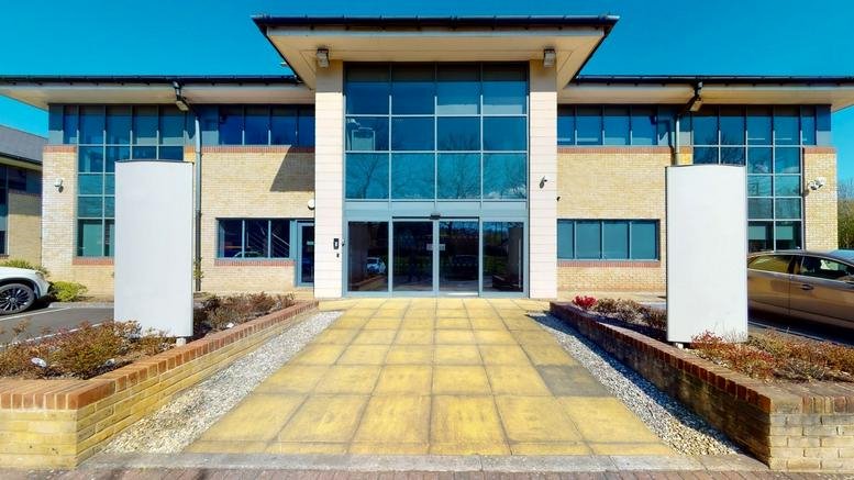 Exterior view of the modern glass and brick facade at Excalibur House, Langstone Business Park.
