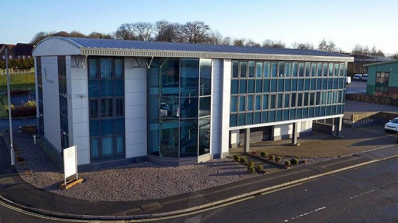 Exterior view of Falcon House featuring a glass facade and modern three-story design.