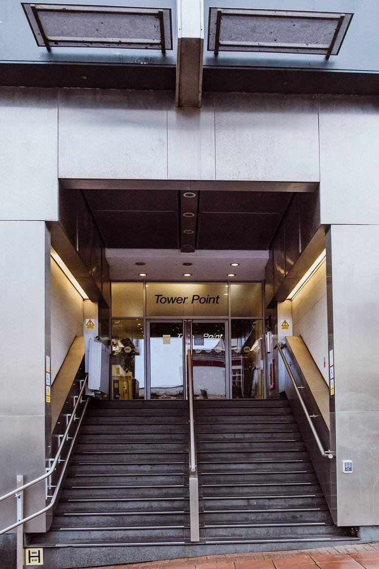 Sleek entrance steps leading into the Tower Point building with modern metal finishes.