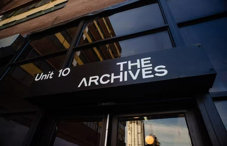 Exterior entrance of The Archives, Unit 10, Fountayne Road, Tottenham, London with black signage.