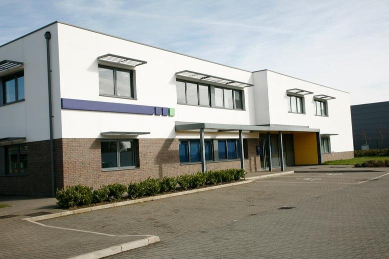 Modern white facade and entrance of the Foxhunter Drive office building in Linford Wood.