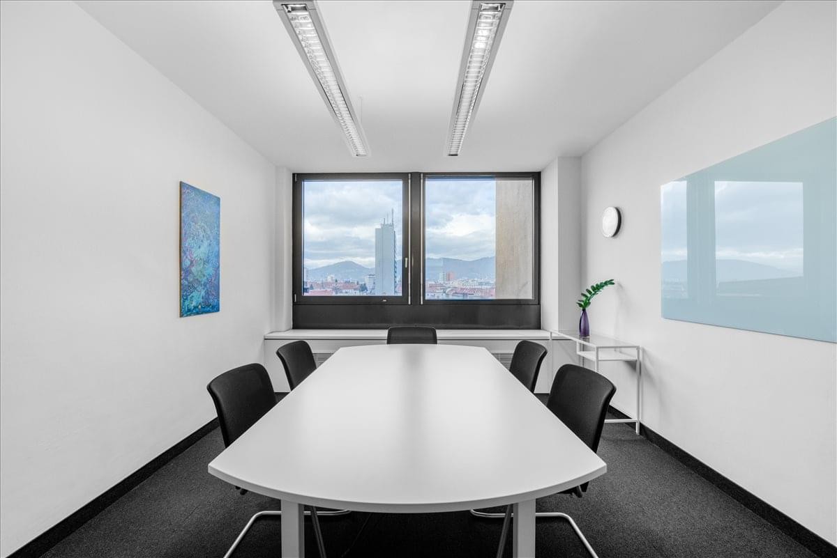 Meeting room at Graz City Tower, Regus City Tower featuring a large white table and city views.