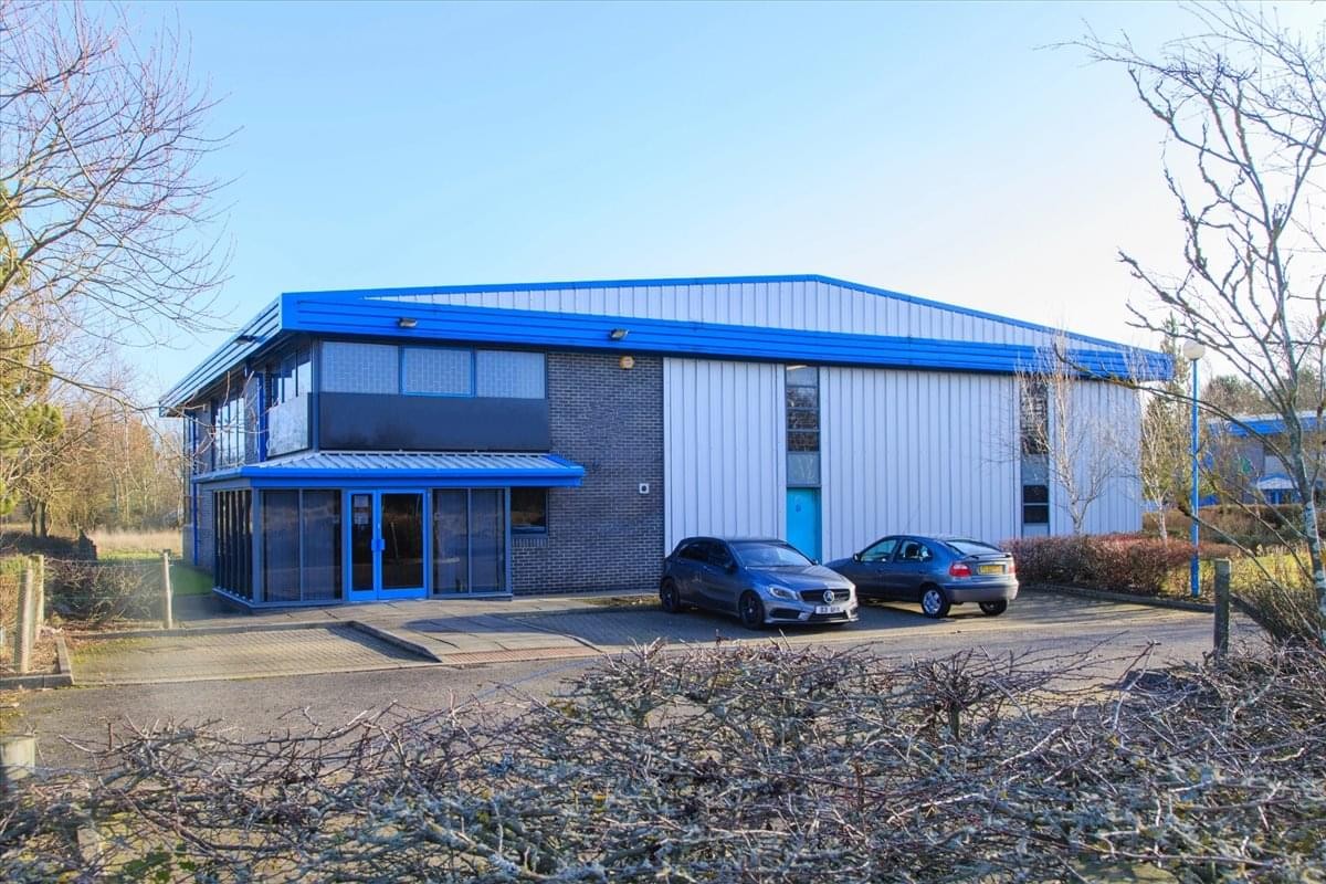 Exterior view of the blue and white warehouse building at Greencroft Industrial Estate.
