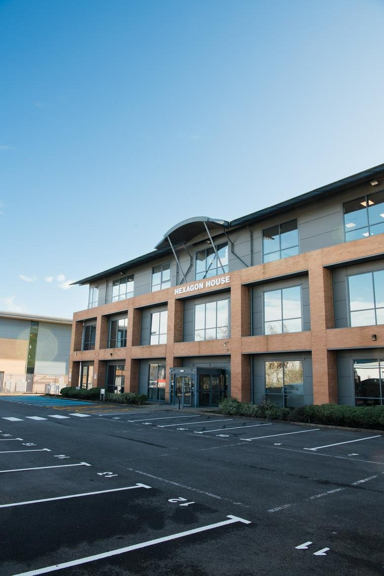 Exterior view of the modern brick and glass facade at Hexagon House.