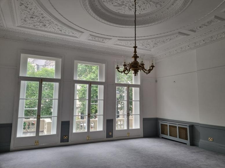 Spacious office with ornate ceiling moldings and large French windows at 20 Grosvenor Gardens.